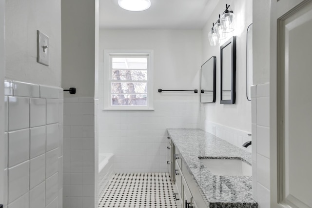 bathroom with vanity, tile patterned flooring, and tile walls