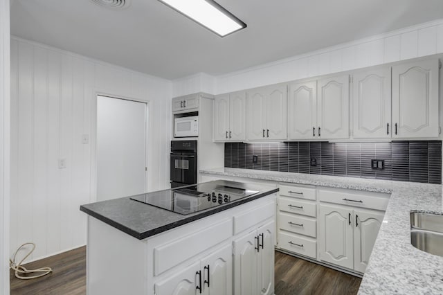 kitchen featuring crown molding, black appliances, white cabinets, a kitchen island, and dark hardwood / wood-style flooring