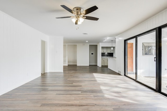 unfurnished room featuring hardwood / wood-style floors and ceiling fan