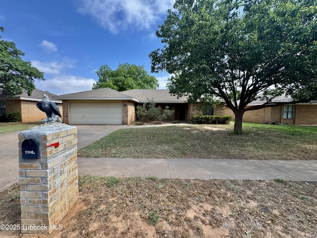 5508 94th St, Lubbock, TX 79424 - view of front of house featuring an attached garage, concrete driveway, brick siding, and a front yard