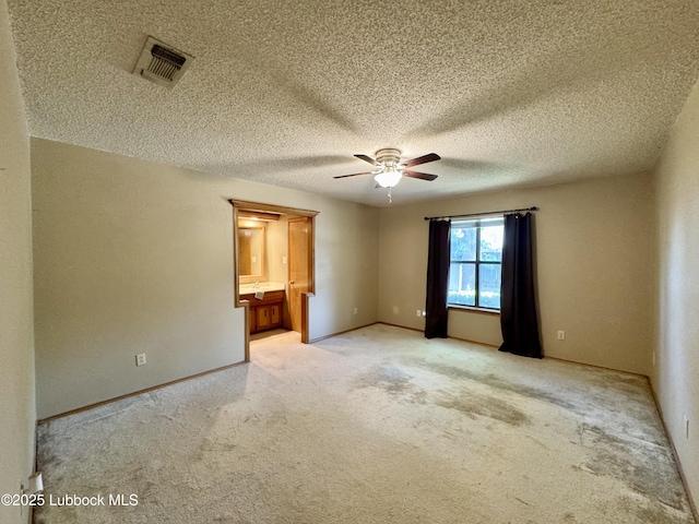 5508 94th St, Lubbock, TX 79424 - empty room featuring a ceiling fan, light colored carpet, a textured ceiling, and baseboards