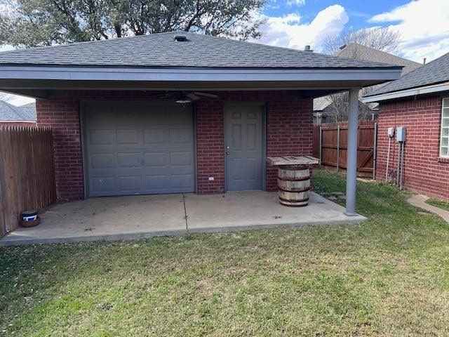 exterior space featuring a garage and a lawn