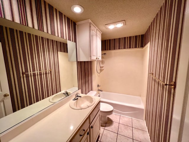 full bathroom featuring toilet, shower / bathing tub combination, a textured ceiling, vanity, and tile patterned flooring