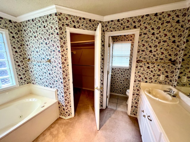 bathroom with a bathtub, vanity, toilet, crown molding, and a textured ceiling