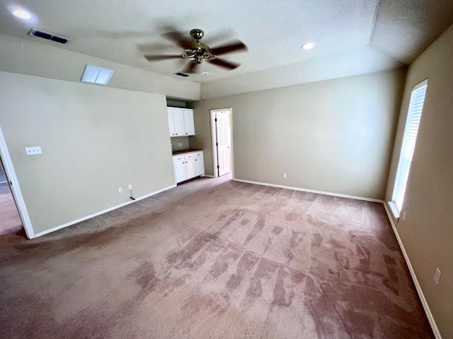 unfurnished living room featuring ceiling fan and carpet