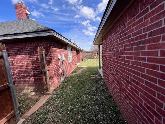 view of side of home with a lawn