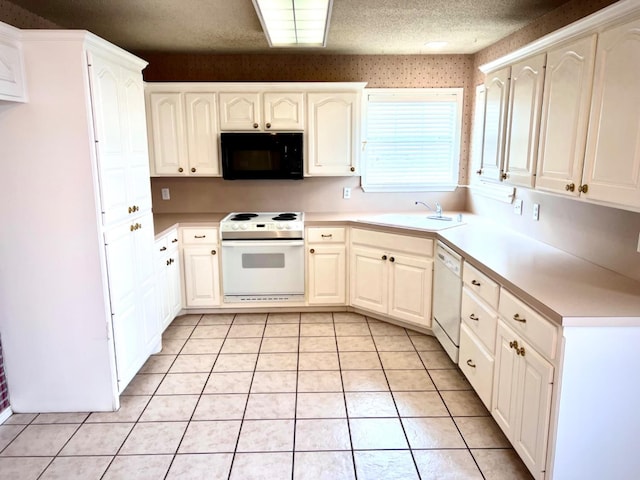 kitchen featuring sink, white appliances, white cabinets, a textured ceiling, and light tile patterned flooring