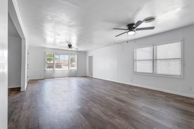 spare room featuring dark wood-type flooring and ceiling fan