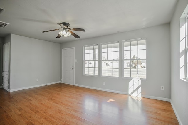 empty room featuring ceiling fan and light hardwood / wood-style flooring