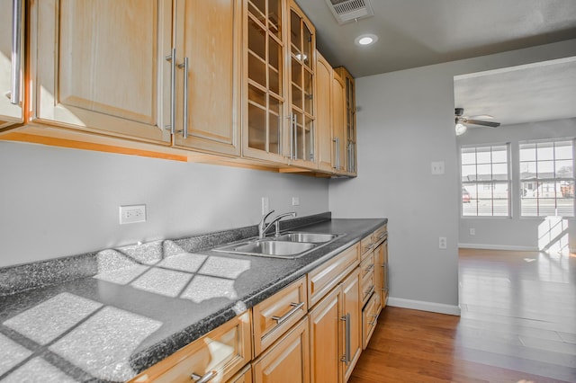 kitchen with sink, ceiling fan, and light hardwood / wood-style flooring