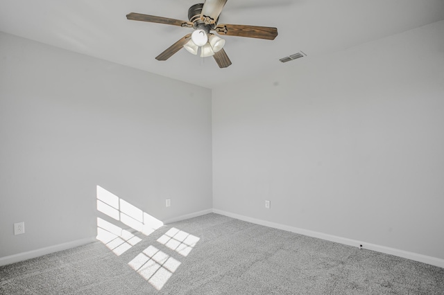 spare room with ceiling fan and carpet