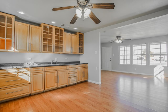 kitchen featuring ceiling fan, sink, light brown cabinetry, and light hardwood / wood-style flooring