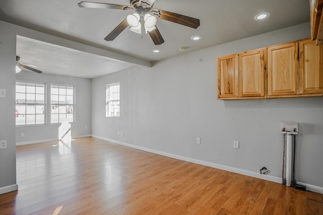 spare room featuring ceiling fan and light wood-type flooring