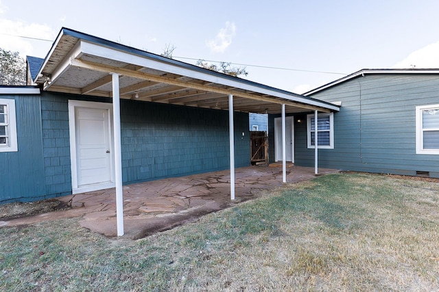 rear view of property featuring a lawn