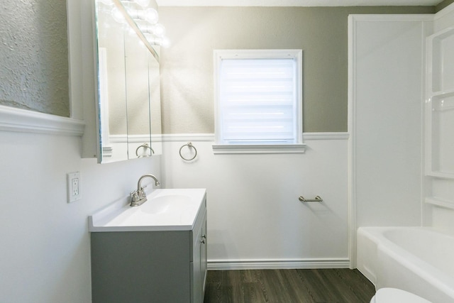 bathroom with vanity, toilet, and wood-type flooring