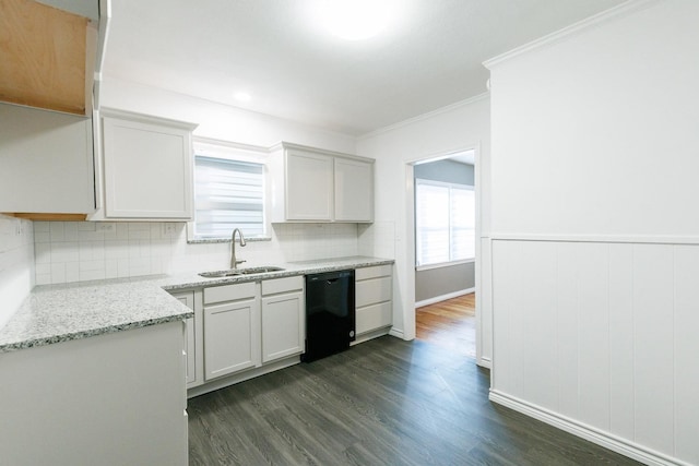 kitchen featuring sink, light stone counters, dark hardwood / wood-style floors, black dishwasher, and white cabinets