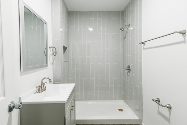 bathroom featuring vanity and a tile shower