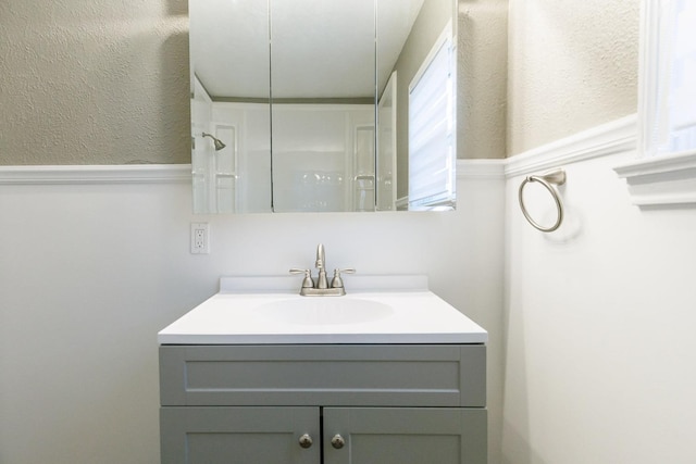 bathroom with vanity and walk in shower