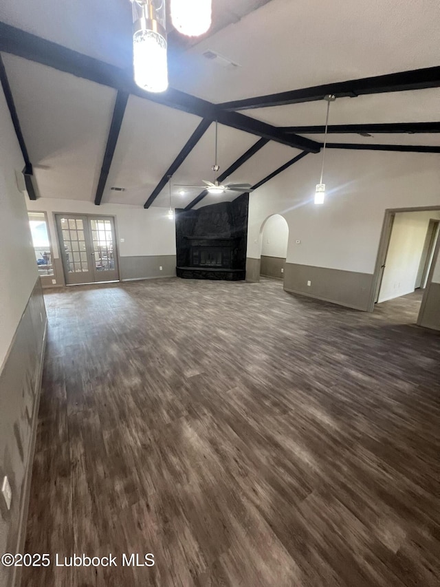 3535 W State Rd 300, Levelland, TX 79336 - unfurnished living room featuring arched walkways, dark wood finished floors, ceiling fan, and a premium fireplace