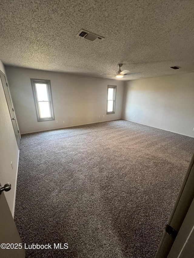 3535 W State Rd 300, Levelland, TX 79336 - spare room with carpet floors, a ceiling fan, and a textured ceiling