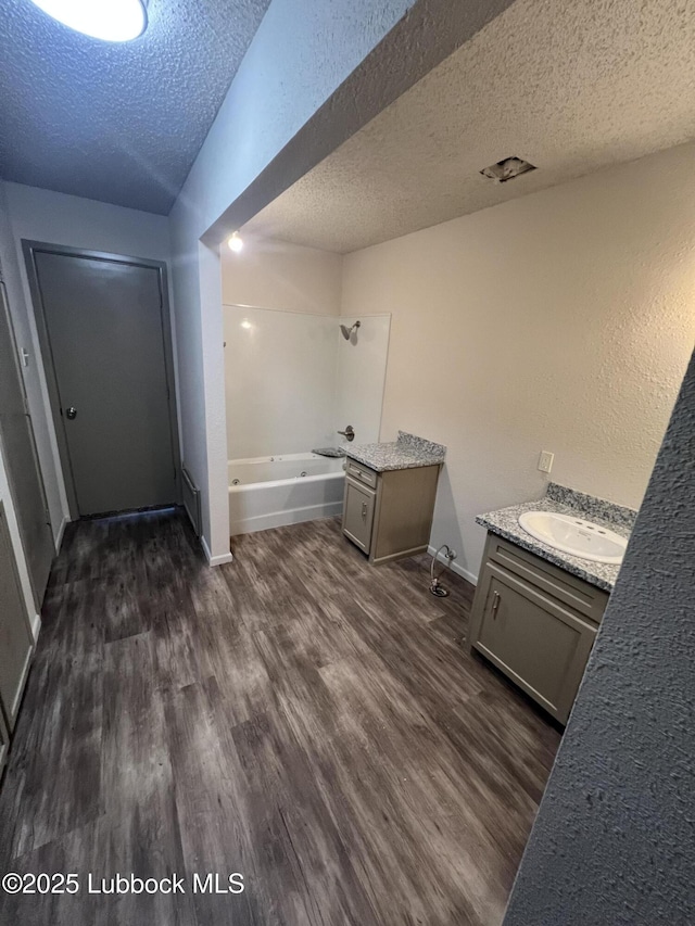 3535 W State Rd 300, Levelland, TX 79336 - bathroom with a textured ceiling, vanity, and wood finished floors
