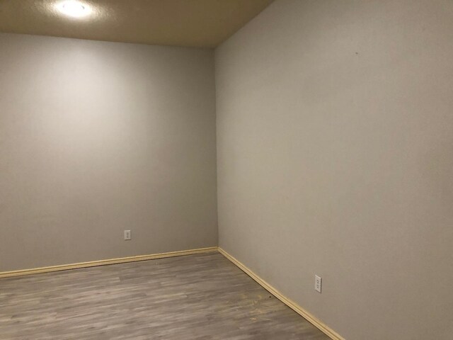 empty room with wood-type flooring