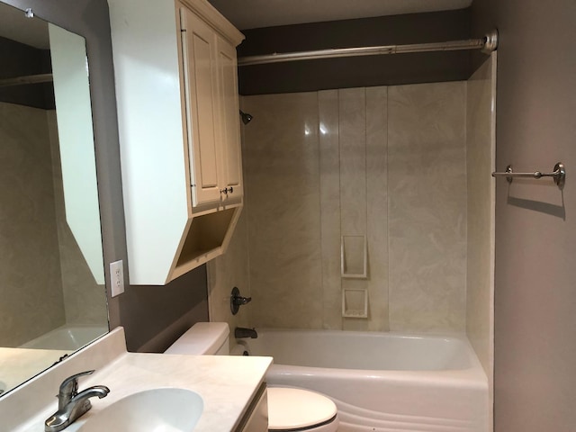 full bathroom featuring vanity, tiled shower / bath, and toilet