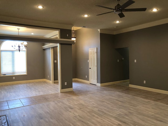 unfurnished room with ornamental molding, ceiling fan with notable chandelier, and light hardwood / wood-style flooring