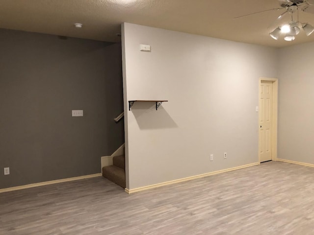 unfurnished room with ceiling fan and light wood-type flooring