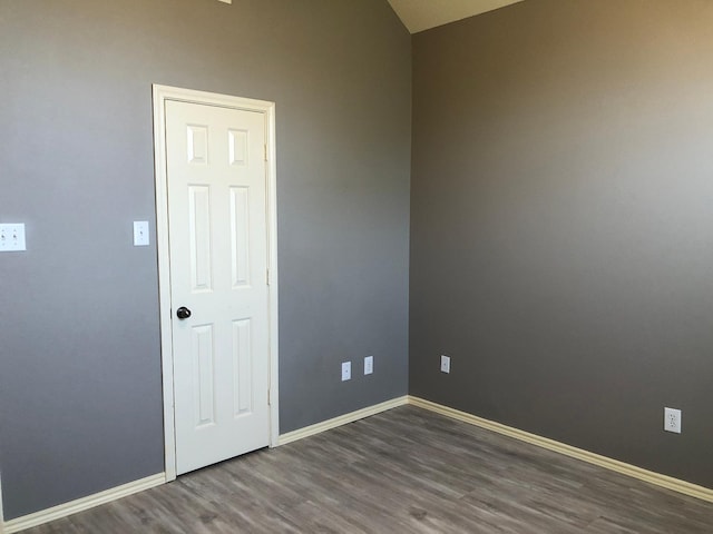 spare room with dark hardwood / wood-style floors