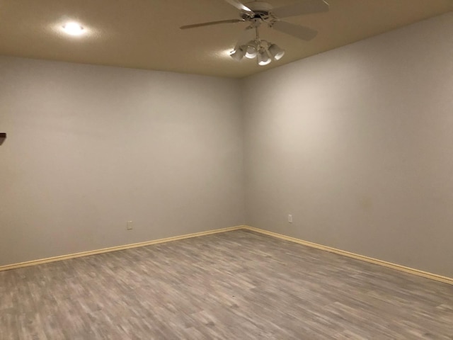 unfurnished room with hardwood / wood-style flooring and ceiling fan