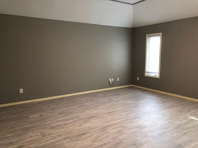 unfurnished room featuring dark wood-type flooring