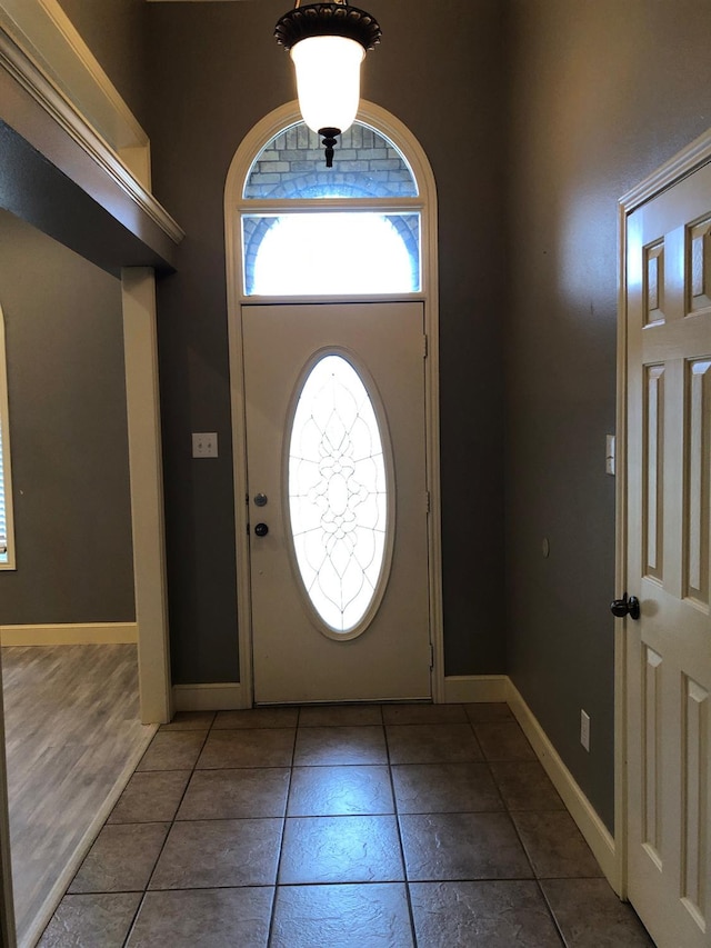 foyer featuring dark tile patterned flooring