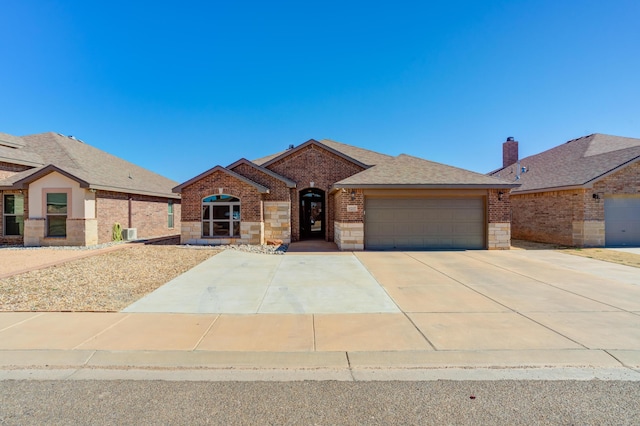 9207 Trenton Ave, Lubbock, TX 79424 - view of front of property featuring brick siding, a garage, driveway, and roof with shingles