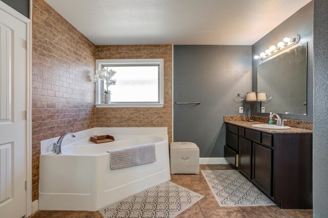 9207 Trenton Ave, Lubbock, TX 79424 - full bath featuring a garden tub, vanity, and tile patterned floors