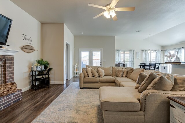 9207 Trenton Ave, Lubbock, TX 79424 - living room featuring dark wood-type flooring, plenty of natural light, ceiling fan, and a fireplace