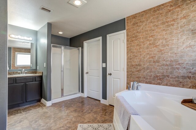 9207 Trenton Ave, Lubbock, TX 79424 - full bathroom with a bath, a shower stall, vanity, and brick wall