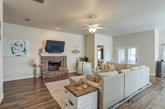 9207 Trenton Ave, Lubbock, TX 79424 - living area with wood finished floors, a ceiling fan, and a brick fireplace