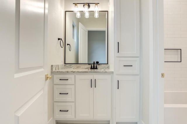 bathroom with tiled shower / bath combo and vanity