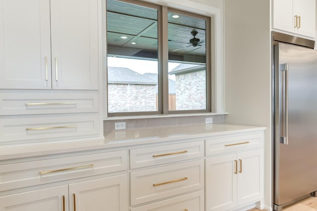 kitchen featuring white cabinetry, high quality fridge, and ceiling fan