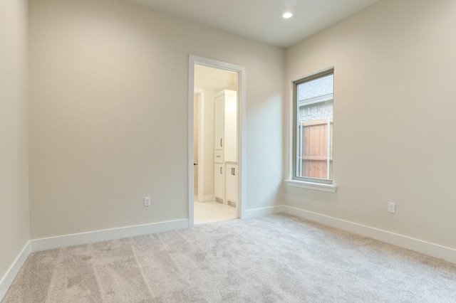 empty room featuring light colored carpet