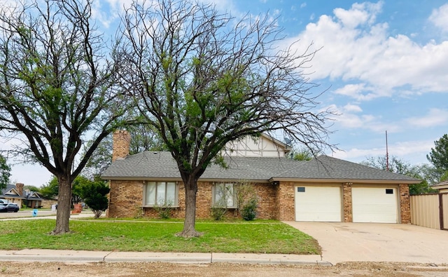 ranch-style home featuring a garage and a front lawn