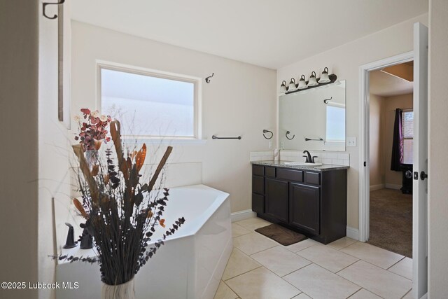 11104 Englewood Ave, Lubbock, TX 79424 - full bathroom with vanity, baseboards, a bath, and tile patterned flooring