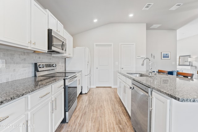3222 Waverly Ave, Lubbock, TX 79407 - kitchen featuring stainless steel appliances, lofted ceiling, white cabinets, stone counters, and decorative backsplash