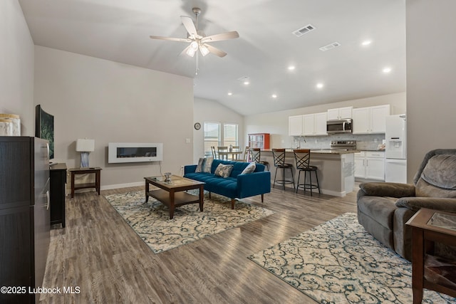 3222 Waverly Ave, Lubbock, TX 79407 - living area featuring vaulted ceiling, ceiling fan, wood finished floors, and recessed lighting