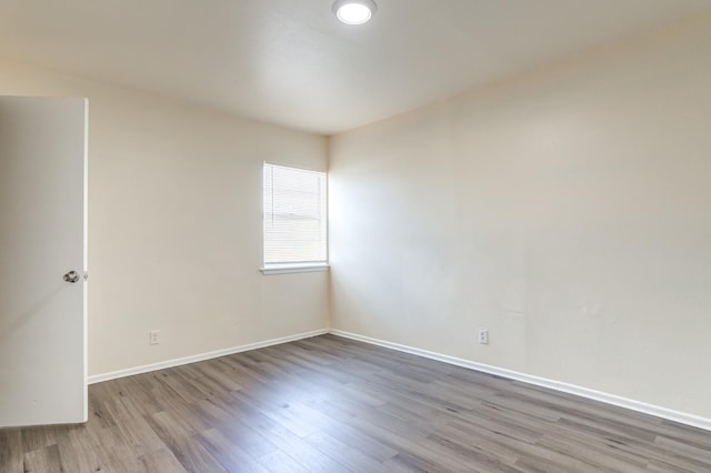 unfurnished room with wood-type flooring