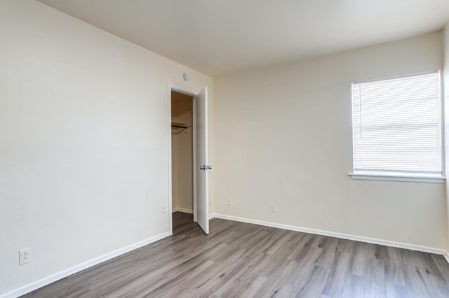 unfurnished bedroom with a closet and light hardwood / wood-style flooring