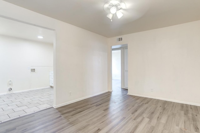 empty room featuring ceiling fan and light hardwood / wood-style flooring