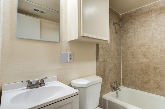 full bathroom with vanity, toilet, and tiled shower / bath