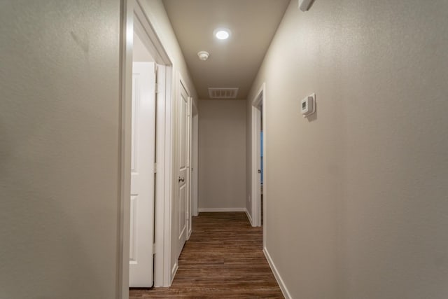 corridor with dark hardwood / wood-style floors